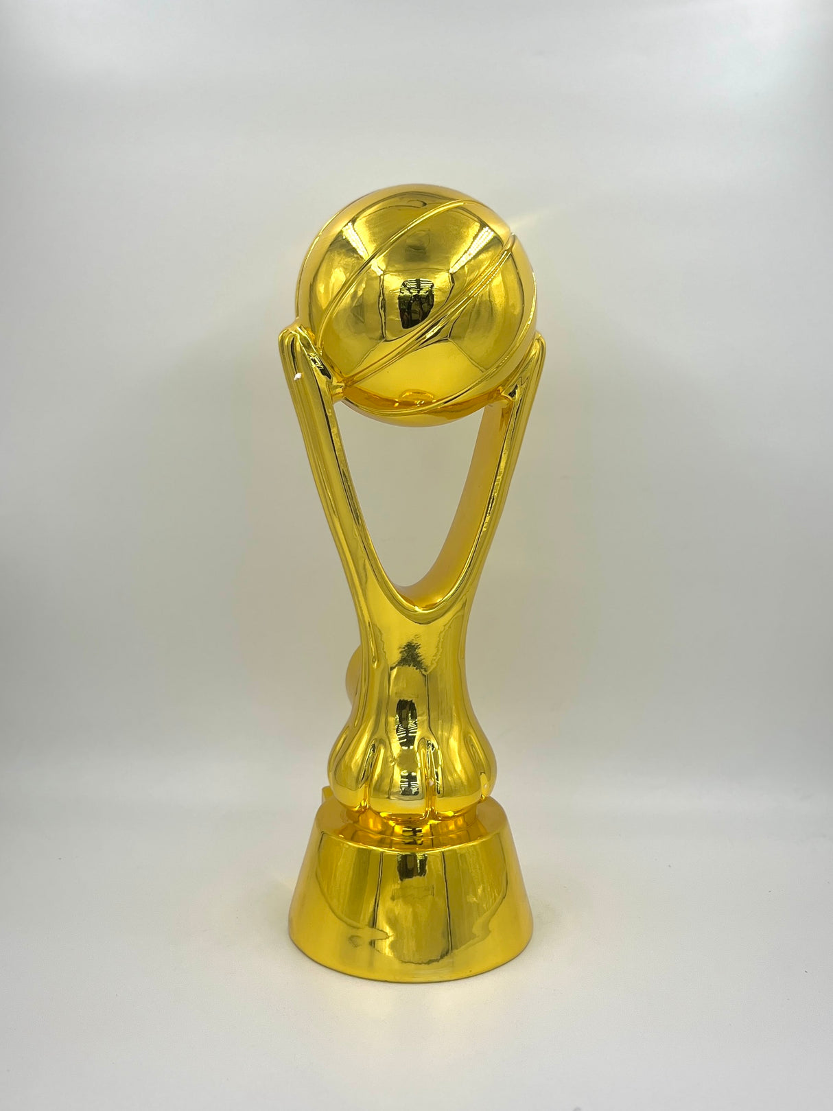 Gold basketball trophy with a black base on a white background.