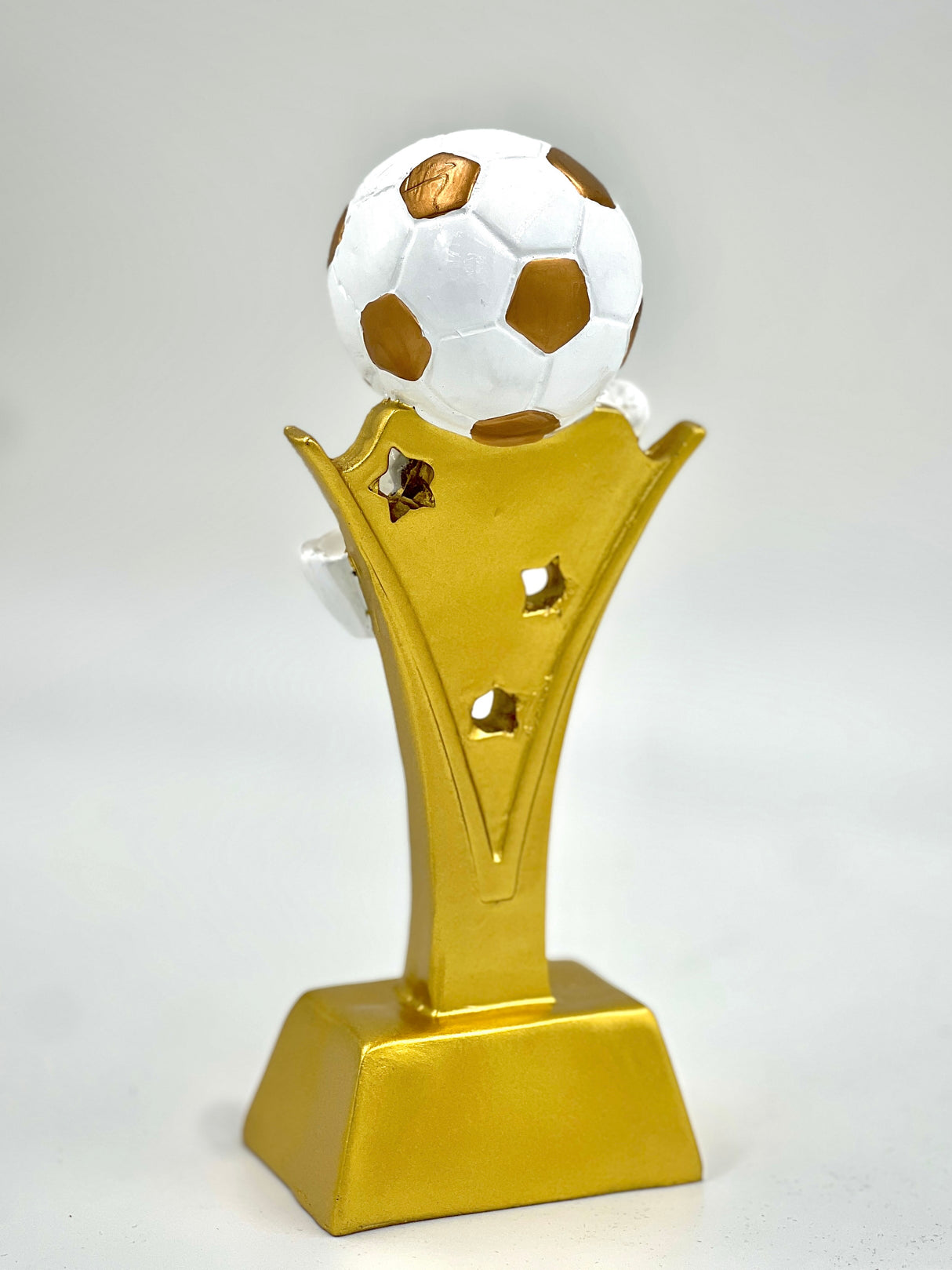 Dynamic gold football award with a realistic paneled ball and decorative riser.