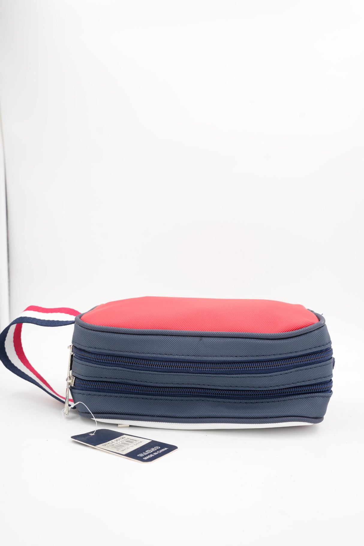 Tommy Today cosmetics or travel accessory bag, front view on gray background
