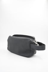 Compact cosmetic or shaving bag in black, side view with handle