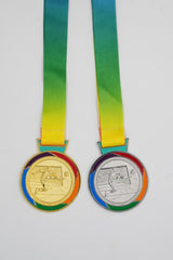Gold and silver football medals with rainbow ribbon for winners
