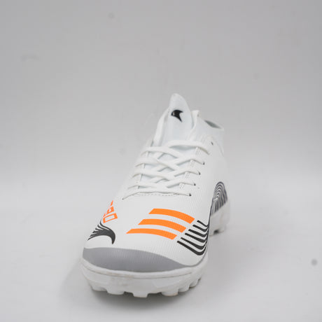 Side view of a white turf football shoe featuring orange stripes, dynamic black line details, and a rubber studded outsole designed for artificial grass.