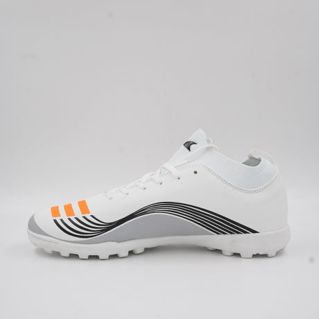 Side view of a white turf football shoe featuring orange stripes, dynamic black line details, and a rubber studded outsole designed for artificial grass.