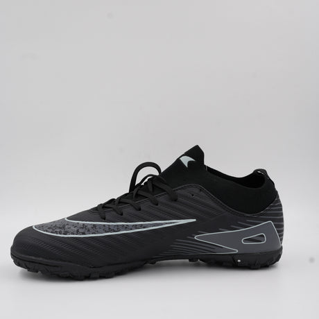 ack angle of the black turf shoe highlighting the flexible ankle support and the durable studded rubber sole for sports performance.
