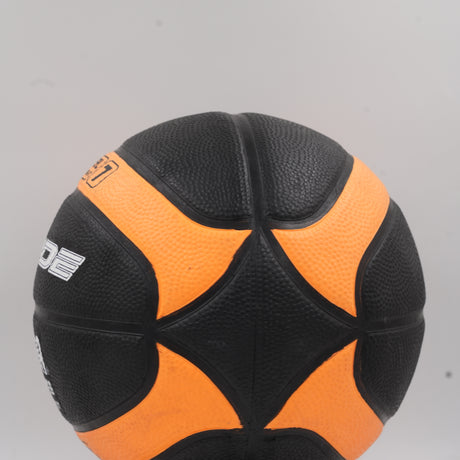 Close-up of the official size and weight text on the high-quality black and orange Pride basketball.