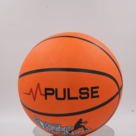 Close-up of the bold black Pulse logo and Street Basketball design on the orange pebbled surface.