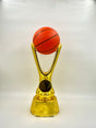 Gold trophy with an orange basketball on top against a white background.