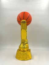 Shiny metallic gold trophy featuring a realistic textured basketball and a dynamic riser.