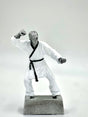 Silver martial arts trophy statue in a fighting pose with a black belt on a gray base.