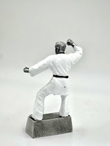 Detailed figure of a Karate or Taekwondo student wearing a white uniform and black belt.