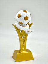 Gold trophy with a black and white soccer ball on top against a white background.