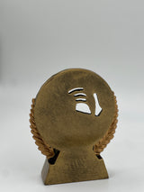 Antique bronze circular trophy depicting racket sports equipment in a detailed relief.