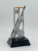 Detailed silver and gold cricket award showcasing stumps, a bat, and a ball, ideal for Man of the Match or league MVP.