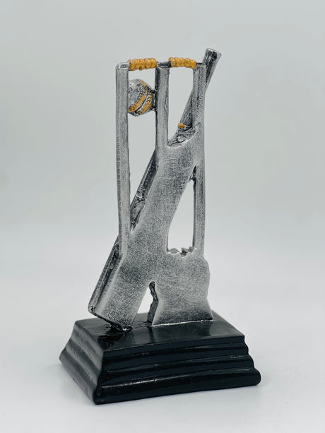 Detailed silver and gold cricket award showcasing stumps, a bat, and a ball, ideal for Man of the Match or league MVP.