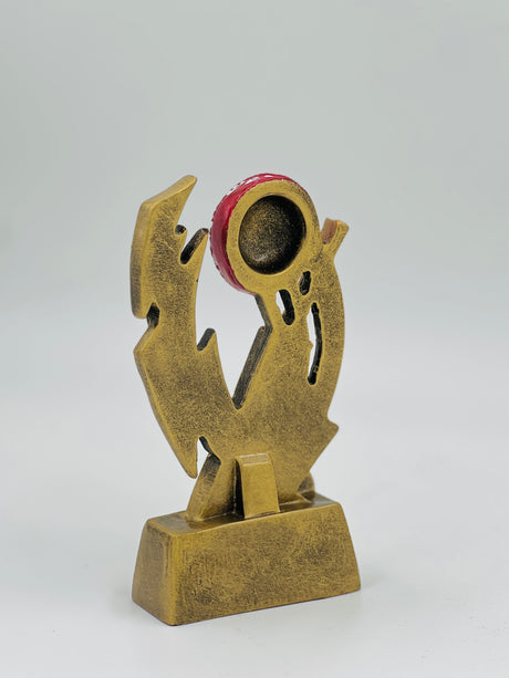 Modern gold resin cricket award with a vibrant red ball centerpiece, ideal for contemporary tournament and club prizes.