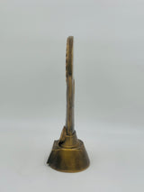 Close-up of a small, resin-cast bronze trophy for table tennis tournaments, showcasing a gold star accent and a central circular motif.