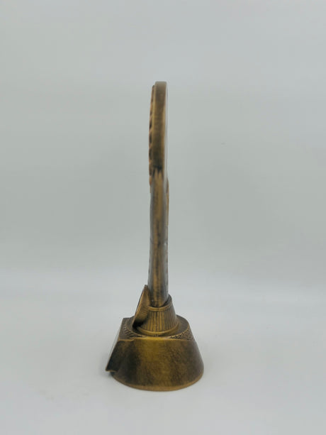 Close-up of a small, resin-cast bronze trophy for table tennis tournaments, showcasing a gold star accent and a central circular motif.