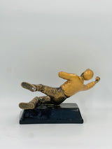 Detailed bronze award figure for Best Striker, Goal Scorer, or Save of the Match, capturing a powerful horizontal pose.