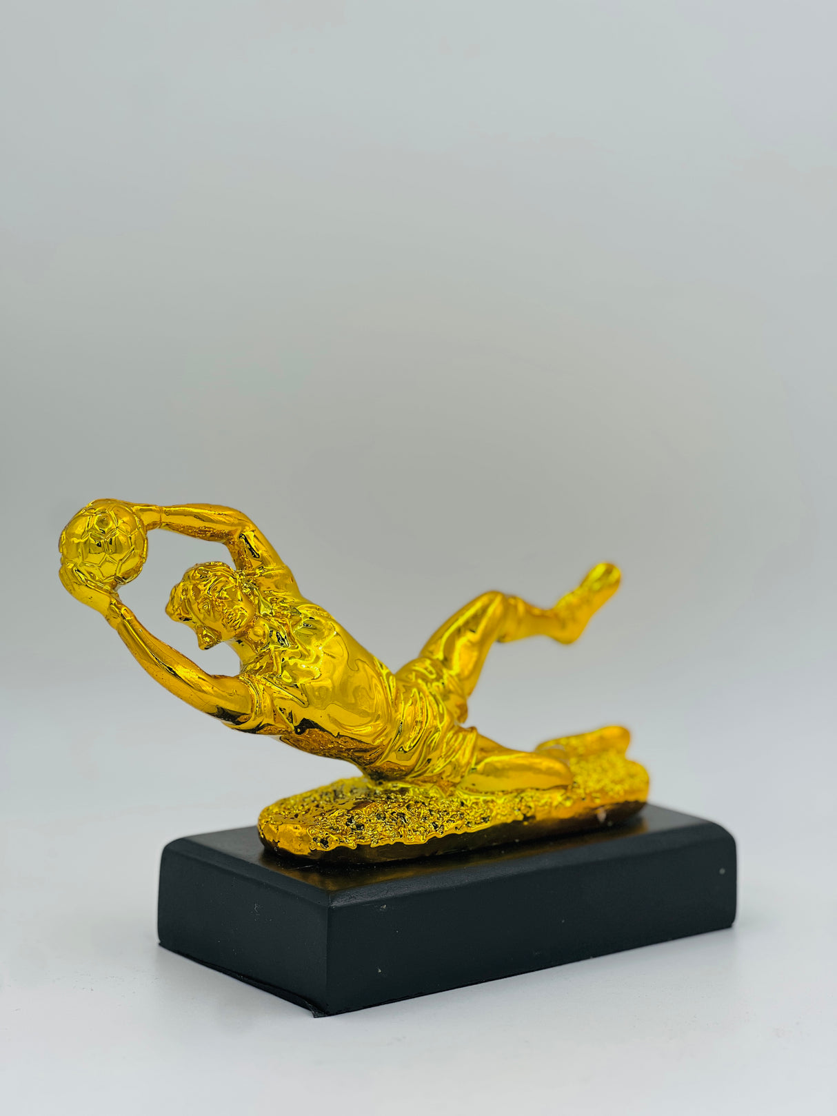 Stunning gold football trophy—perfect for honoring match-winning saves, heroic tackles, and exceptional defensive play.
