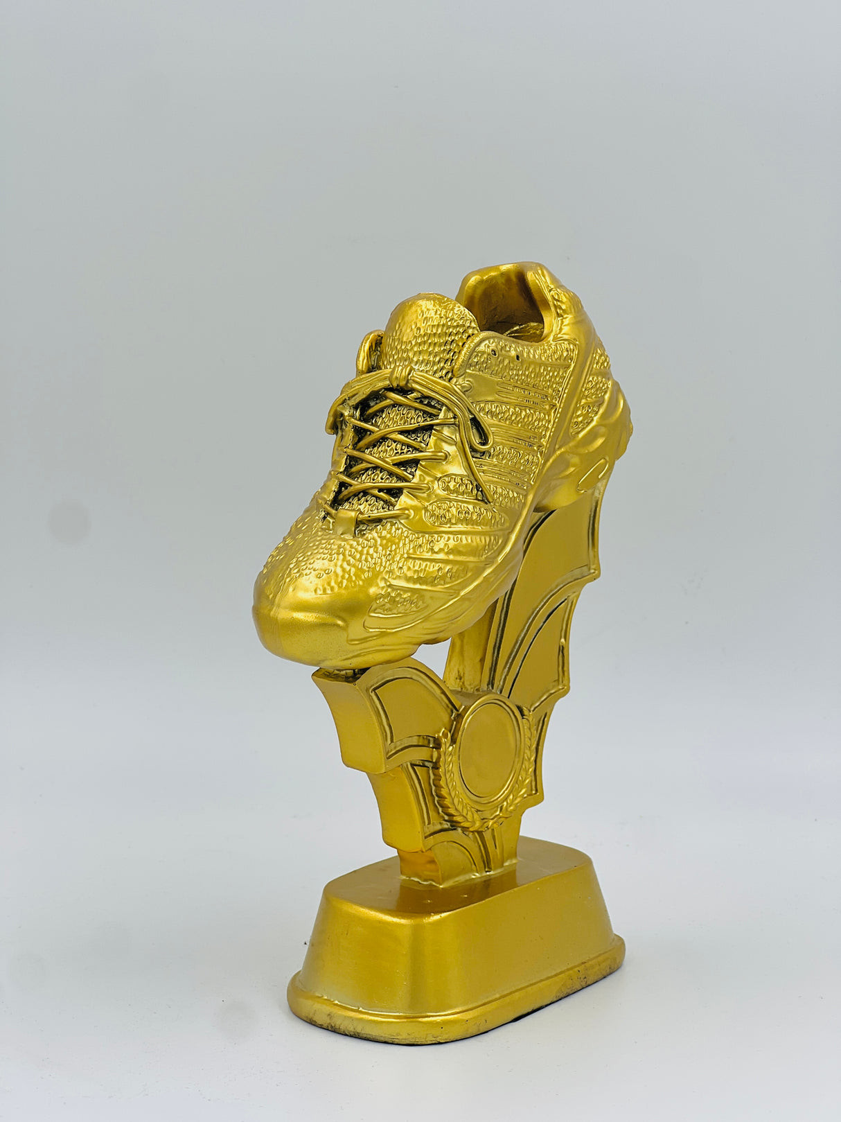 Shining gold sports award featuring a lifelike soccer shoe atop a decorative pedestal, perfect for league MVP or Golden Shoe winner.