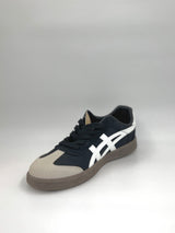 Navy and beige sneaker with white logo on a gray background