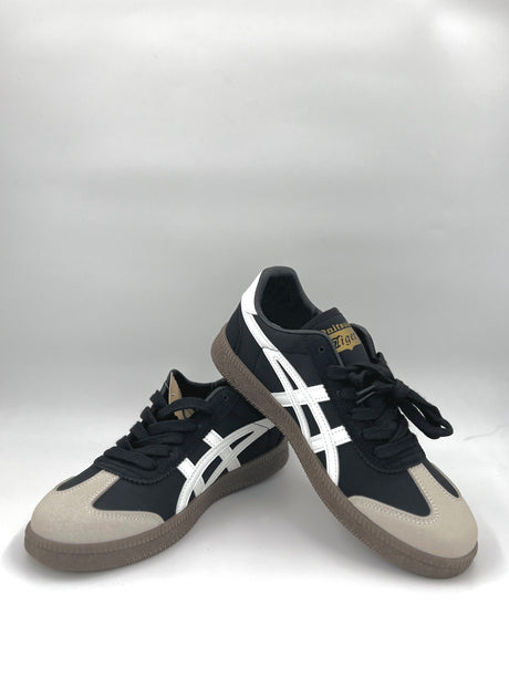 Black and white sneakers with beige accents on a white background