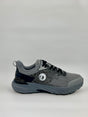Gray and black athletic shoe on a light gray background