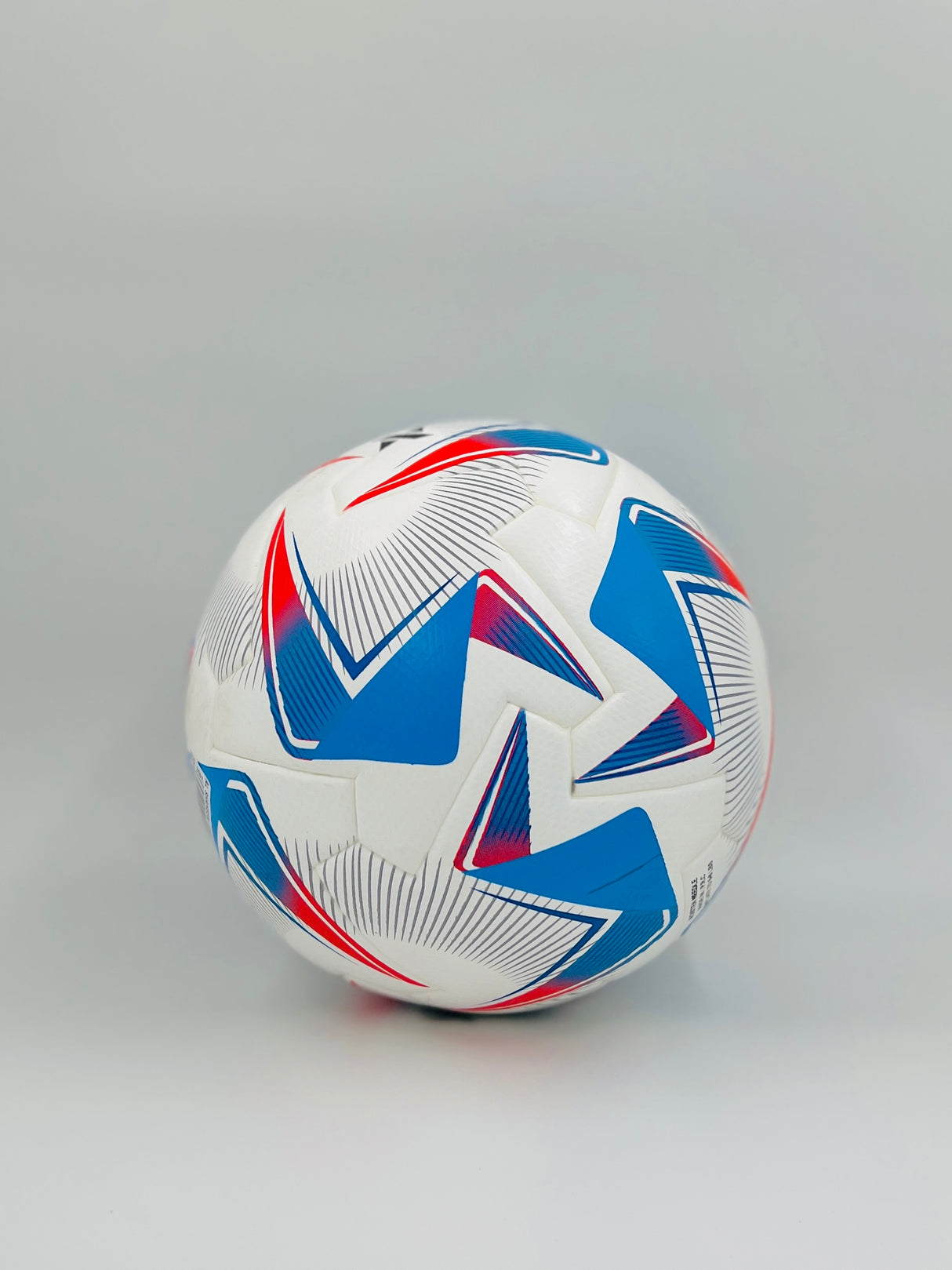 Soccer ball with blue and red patterns on a gray background