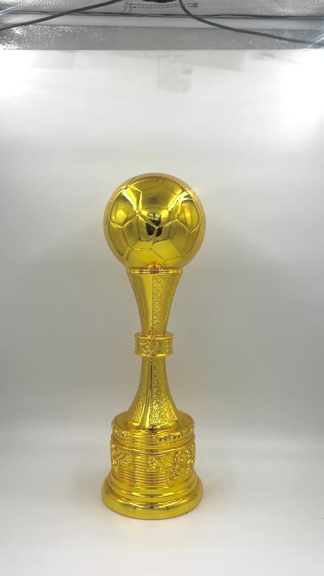 Elegant gold award trophy with a heavily detailed column and high-gloss finish.